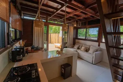a kitchen and living room with a couch and a stove at Pura Villa in Uluwatu in Jimbaran
