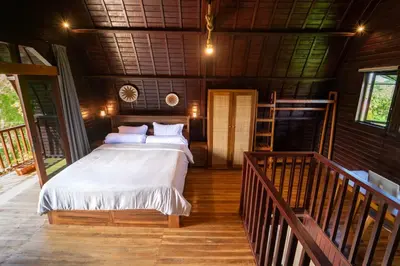 a bedroom with a large bed in a house at Pura Villa in Uluwatu in Jimbaran