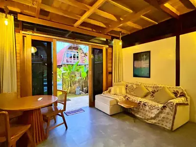 a living room with a couch and a table and a tableablish at Makaha Bungalow in Jimbaran