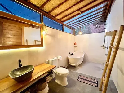 a bathroom with a sink and a toilet at Makaha Bungalow in Jimbaran