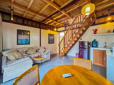 a living room with a couch and a table at Makaha Bungalow in Jimbaran