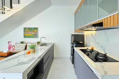 a kitchen with white countertops and a stove top oven at Ghayda Entire 3 BR Private Pool Villa in Seminyak