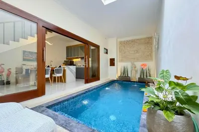 a swimming pool in the middle of a house at Ghayda Entire 3 BR Private Pool Villa in Seminyak
