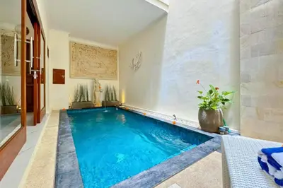 a swimming pool in the middle of a house at Ghayda Entire 3 BR Private Pool Villa in Seminyak