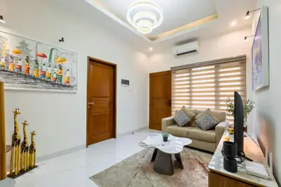 a living room with a couch and a table at Ghayda Entire 3 BR Private Pool Villa in Seminyak
