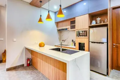 a kitchen with a sink and a refrigerator at Belisaria Comfortable 3 BR Private Pool Villa in Sanur