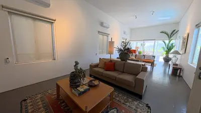 a living room with a couch and a table at Naiika villa in Seminyak