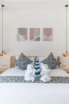 two stuffed animals are sitting on a bed at Villa Kusuma 3 Seminyak in Badung