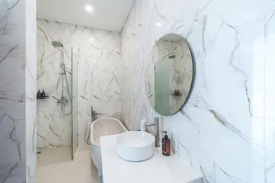 a white bathroom with a sink and a mirror at Villa Kusuma 3 Seminyak in Badung