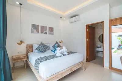 a bedroom with a bed with a teddy bear on it at Villa Kusuma 3 Seminyak in Badung