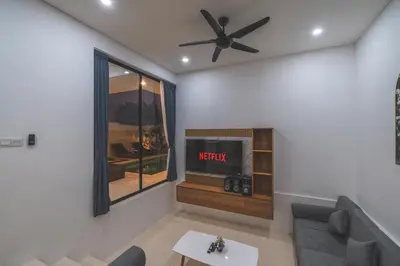 a living room with a tv and a ceiling fan at Villa Kusuma 3 Seminyak in Badung