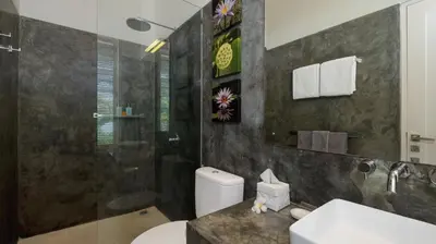 a bathroom with a toilet and a shower at Villa Merta Sari 10 by Villa Finder in Seminyak