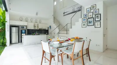 a kitchen and dining room with a table and chairs at Villa Merta Sari 10 by Villa Finder in Seminyak
