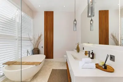 a bathroom with a tub and a toilet and a sink at Luxury Villa in Berawa Beach 3BR - Canggu in Canggu