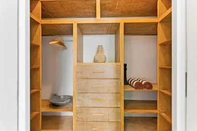 a wooden closet with wooden shelves and cabinets at Luxury Villa in Berawa Beach 3BR - Canggu in Canggu