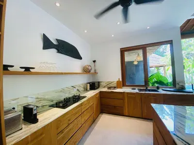a kitchen with a fish tank and a window at villa Pacha 2 in Seminyak