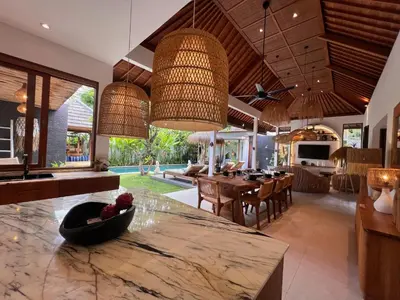 an open kitchen and living room with a large island at villa Pacha 2 in Seminyak