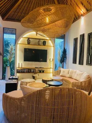 a living room with a large couch and a television at villa Pacha 2 in Seminyak
