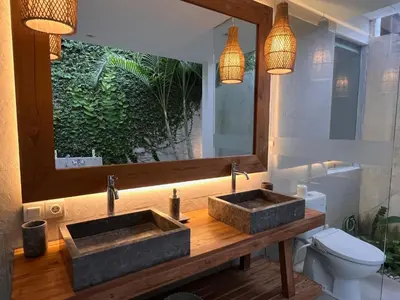 a bathroom with two sinks and a toilet at villa Pacha 2 in Seminyak