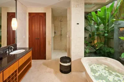 a bathroom with a bath tub and an aquarium at Calista Peaceful 4 BR Private Pool Villa in Canggu