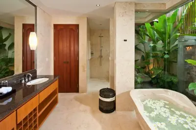 a bathroom with a bath tub and an aquarium at Calista Peaceful 4 BR Private Pool Villa in Canggu
