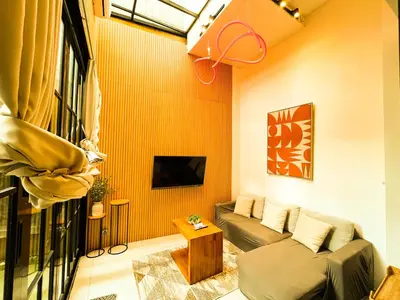 a living room with a couch and a tv at Villa Mikhail Seminyak in Seminyak