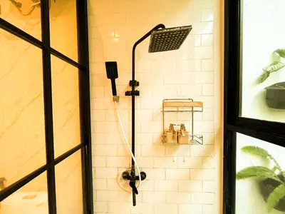 a shower with a shower head in a bathroom at Villa Mikhail Seminyak in Seminyak