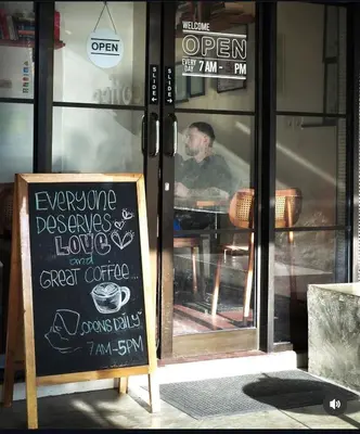 a chalkboard sign in front of a coffee shop at Villa Mikhail Seminyak in Seminyak
