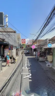 a street with a train tracks on a city street at Okie house hotel in Legian
