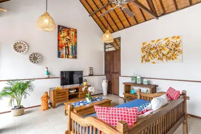 a living room with a couch and a tv at Villa Alamanda, central location and close to restaurants in Seminyak