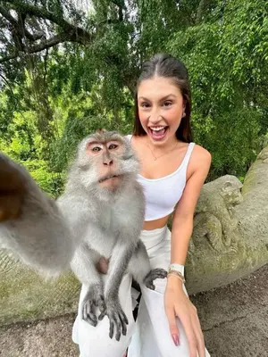 a woman holding a monkey on her arms at Ubud Classic Day Trip in Pesanggaran
