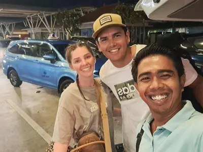 three people posing for a picture in a parking lot at Ubud Classic Day Trip in Pesanggaran