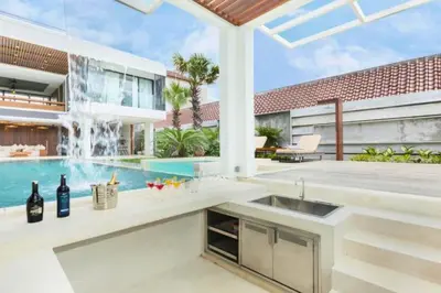 a kitchen with a fountain in front of a house at Tanaya Luxury 4 BR Private Pool Villa in Canggu