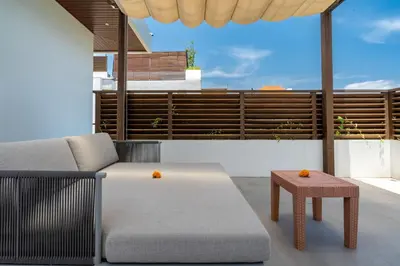 a living room with a couch and a table at Villa Hattala - Luxury Modern Villa in Prime Berawa with Air-Conditioned Living Space in Canggu