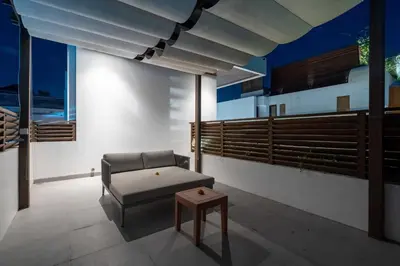 a living room with a couch and a table at Villa Hattala - Luxury Modern Villa in Prime Berawa with Air-Conditioned Living Space in Canggu
