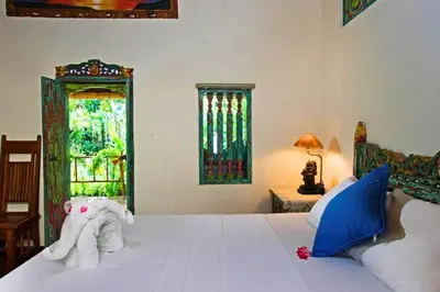 a bedroom with a bed with towels and a window at Andina Spacious Garden 4 BR Private Pool Villa in Seminyak