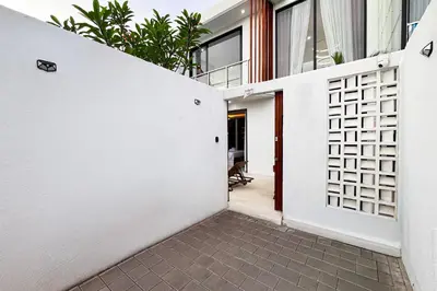 an entrance to a house with a white wall at Modern 2BR Villa Reisi Malindra M12 in Denpasar in Kerobokan