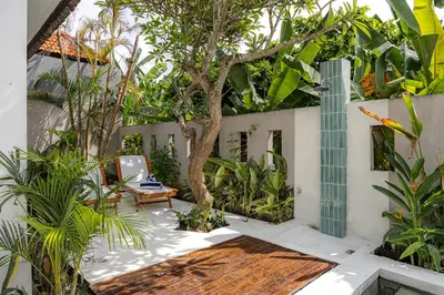 a courtyard with a tree in the middle of a building at Ola - Private Villa - Umalas in Kerobokan