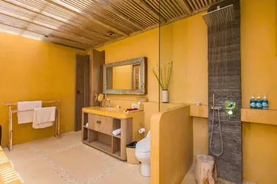 a bathroom with a toilet and a sink and a shower at Kevia Peaceful 3 BR Private Pool Villa in Seminyak