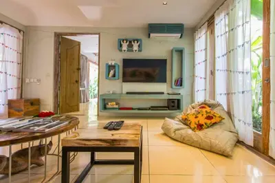 a living room with a bean bag chair and a television at Kevia Peaceful 3 BR Private Pool Villa in Seminyak