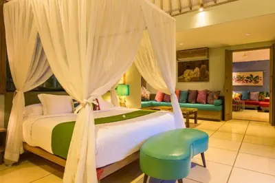 a bedroom with a large bed with a canopy at Kevia Peaceful 3 BR Private Pool Villa in Seminyak