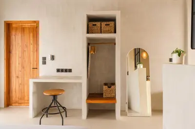 a kitchen with a stool and a refrigerator at Modern 1BR Villa with Private Pool in Kerobokan