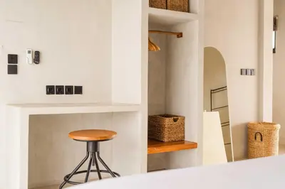 a stool in a room with a wall with a shelf at Modern 1BR Villa with Private Pool in Kerobokan