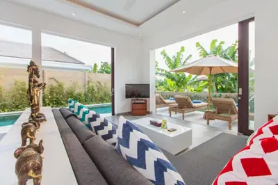 a living room with a couch and a table at Orvala Comfortable 2 BR Private Pool Villa in Seminyak