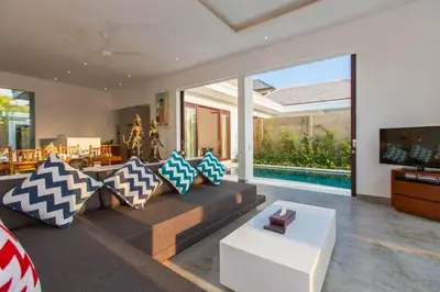 a living room with a couch and a tv at Orvala Comfortable 2 BR Private Pool Villa in Seminyak