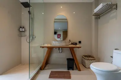 a bathroom with a sink and a glass shower at Springleaf Villa in Nusa Dua