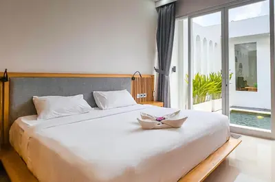 a white bed with a bowl on top of it at Luxurious Semeniyak new 2BR villa with a pool in Seminyak