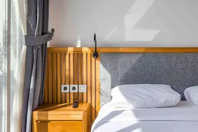 a bedroom with a bed with a wooden head board at Luxurious Semeniyak new 2BR villa with a pool in Seminyak