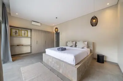 a bedroom with a large bed in a room at Lotus Villa-Cozy 3BR in Canggu in Kerobokan