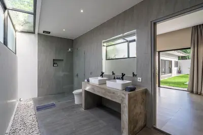 a bathroom with two sinks and a large mirror at Lotus Villa-Cozy 3BR in Canggu in Kerobokan